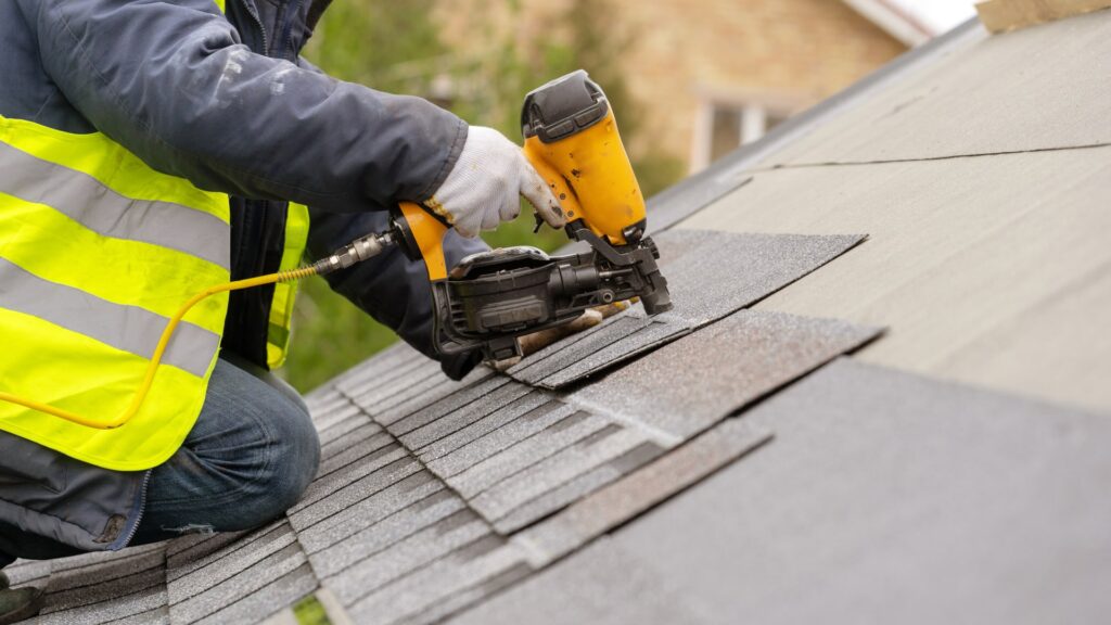 roofer with drill fixing roof